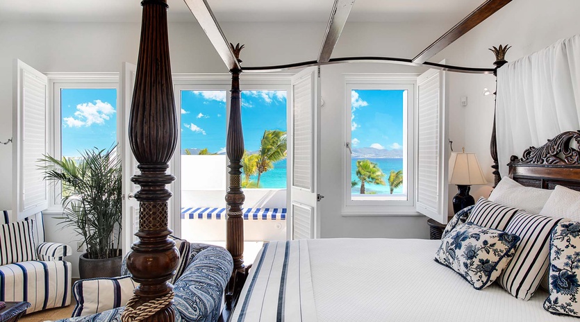 Wake up to breathtaking ocean views framed by elegant shutters. Your private sanctuary features a handcrafted four-poster bed, coastal-inspired décor, and direct access to sun-drenched terraces overlooking turquoise waters.