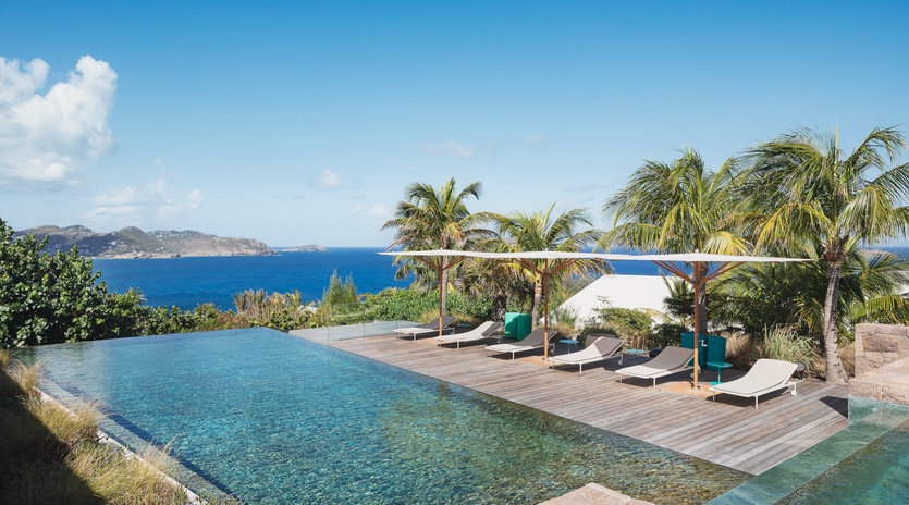 Stunning infinity pool with ocean views and tropical paradise surroundings creates the perfect Caribbean escape.