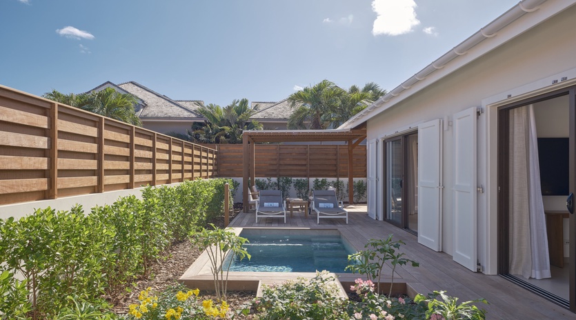 Step onto your private terrace where a sparkling pool awaits, surrounded by tropical blooms and shaded lounging spots for ultimate relaxation.