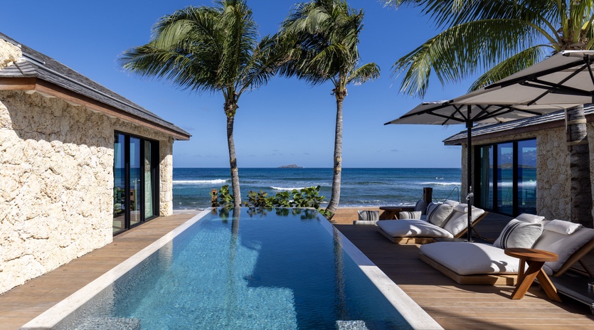 Wake up to your own slice of paradise with an infinity pool overlooking turquoise waters and swaying palms at your beachfront retreat.