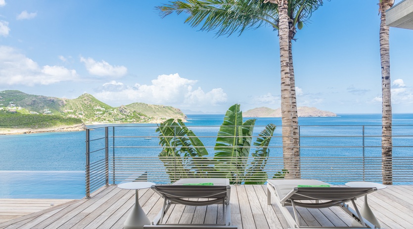 Unwind on your private deck where pristine waters meet tropical paradise, complete with loungers for endless ocean gazing.