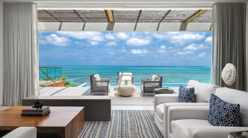Unwind in your private oasis with panoramic ocean views, where plush seating and tropical breezes create the perfect retreat.