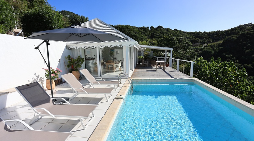 Soak up the sun by your private pool, where tropical breezes and mountain views create the perfect backdrop for relaxation.