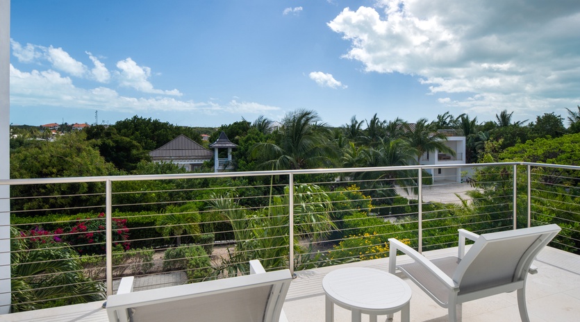 Unwind on your private terrace with panoramic views of lush tropical gardens and palm trees stretching to the horizon.