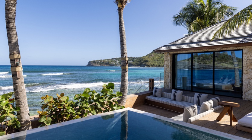 Your private infinity pool melts into ocean views, while plush lounge seating invites you to soak up tropical paradise.