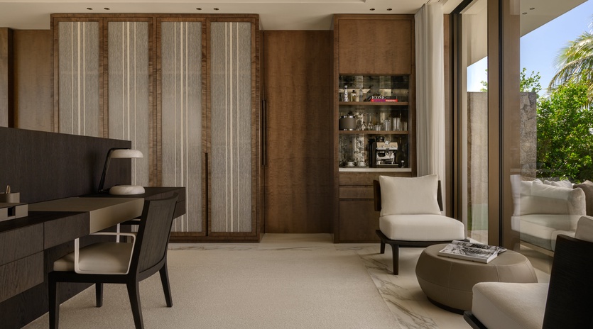 Settle into your sophisticated living space where modern comfort meets tropical elegance, complete with workspace and stunning garden views.