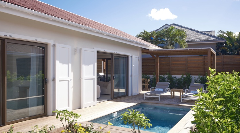Your private paradise awaits with an intimate plunge pool, sun loungers on warm decking, and lush tropical gardens creating your perfect outdoor sanctuary.