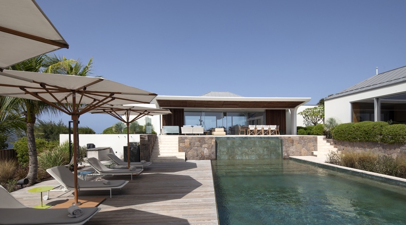 Sleek modern villa with stunning pool and ocean views creates your perfect tropical escape.