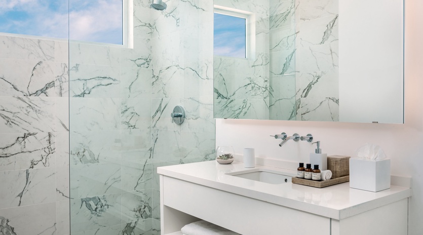 Step into your spa-like retreat with elegant marble walls and a luxurious rainfall shower that transforms your daily routine into pure bliss.