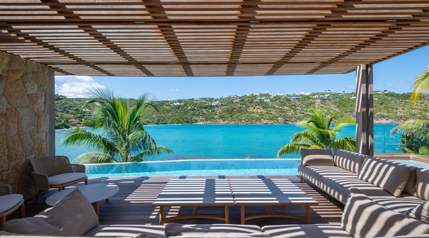 Unwind in your private infinity pool terrace where Caribbean blues meet endless comfort and tropical palm shadows dance overhead.