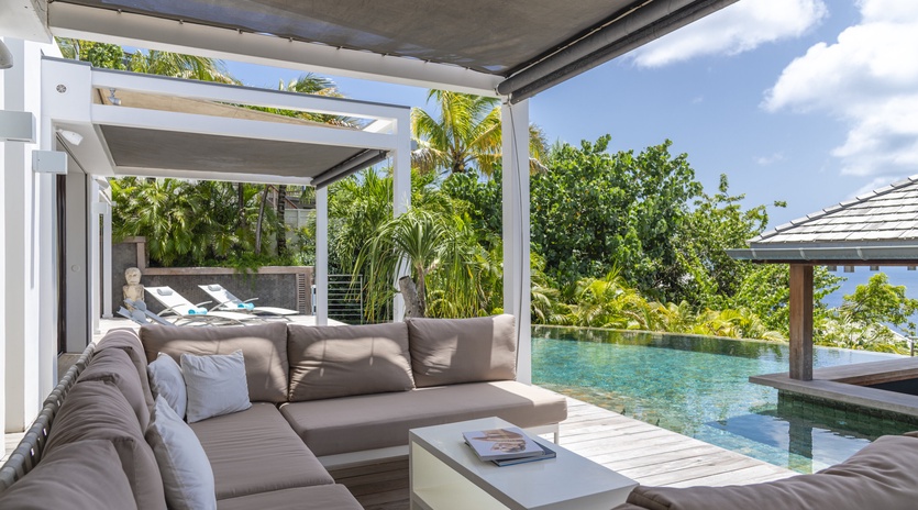 Sink into plush comfort and gaze at your private infinity pool framed by lush tropical palms—your perfect hideaway for quiet mornings or sun-soaked afternoons.