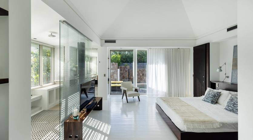 Unwind in your sophisticated suite where natural light streams through floor-to-ceiling windows, creating perfect relaxation vibes.