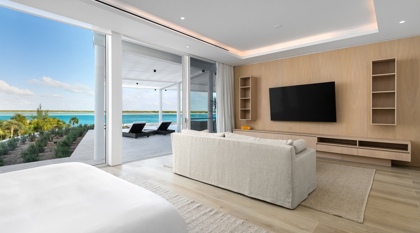 Your sophisticated suite opens to stunning ocean views through floor-to-ceiling windows, where modern comfort meets tropical paradise.