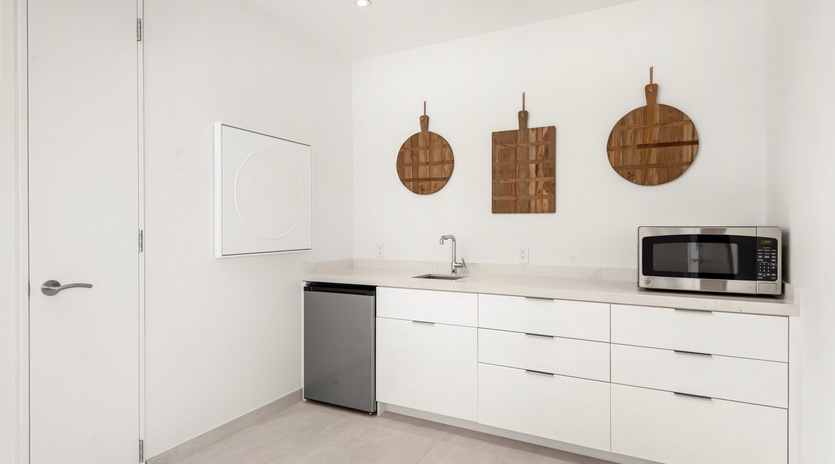 Your sleek white kitchen features modern appliances and stylish wooden cutting boards, perfect for preparing meals during your stay.