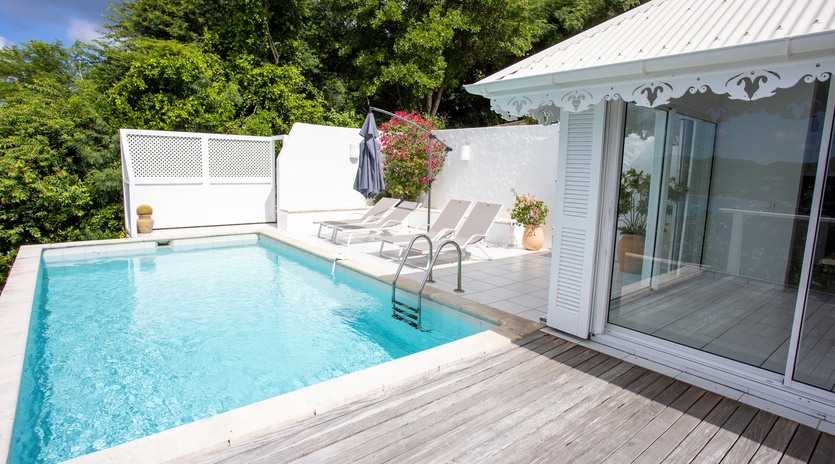 Your private oasis awaits with crystal-clear pool waters and sun loungers for ultimate relaxation on the spacious deck.