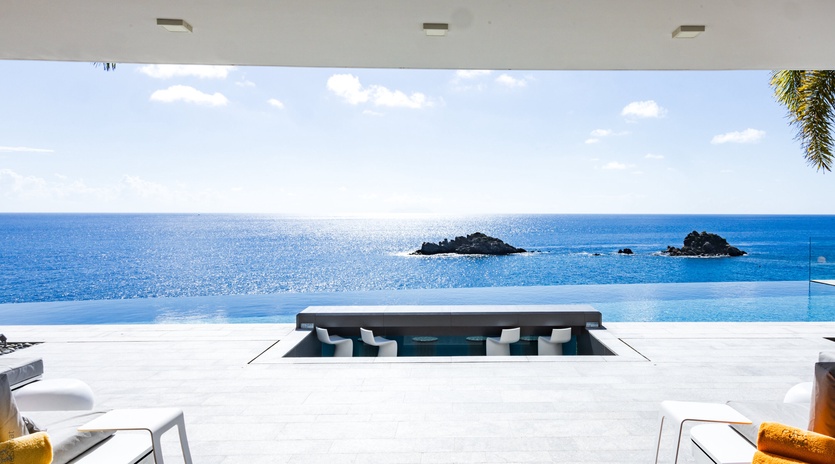 Sink into pure luxury in your infinity pool as endless ocean views and tropical islands create the perfect backdrop for relaxation.