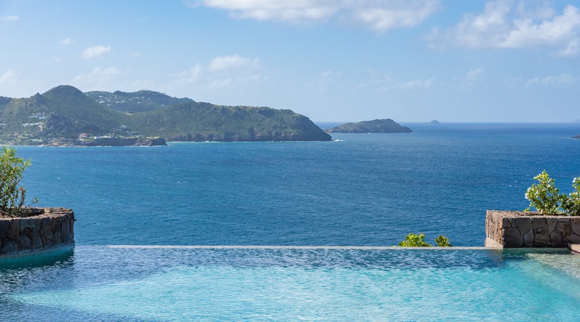 Stunning infinity pool paradise where crystal waters meet endless ocean views and lush tropical islands create your perfect backdrop.