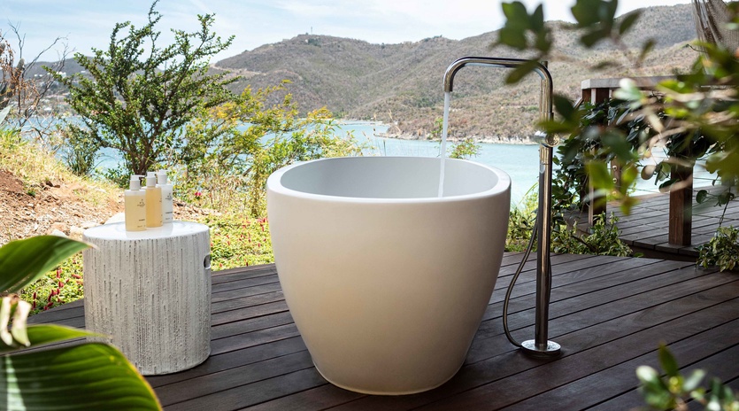 Soak in your private outdoor tub while gazing at stunning coastal mountains and turquoise waters.
