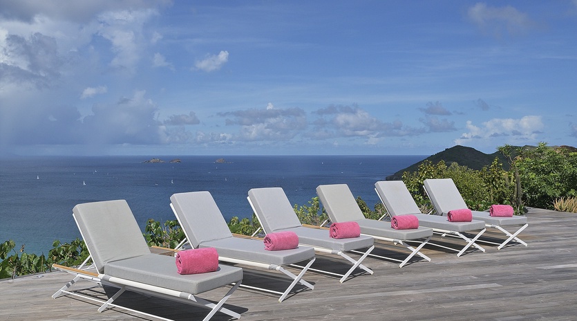 Luxurious deck overlooks endless ocean views with six premium loungers ready for your perfect day of relaxation in paradise.
