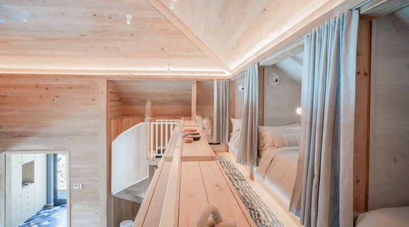 Cozy into your private pod with soft linens and warm wood surrounding you in this intimate dormitory-style retreat.