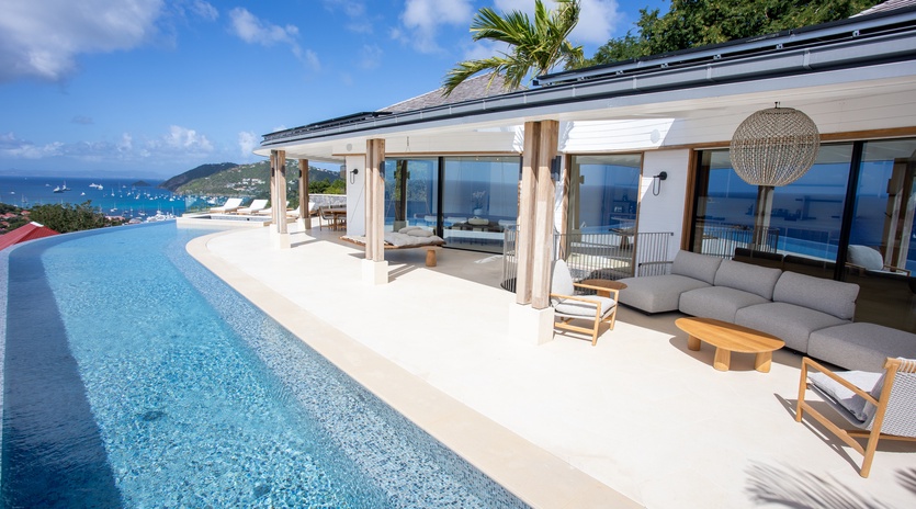 Stunning infinity pool and outdoor terrace with panoramic ocean views and luxury furnishings for the ultimate tropical escape.