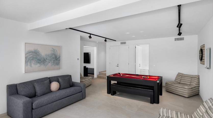 Your private game room awaits with a sleek pool table and cozy seating for unforgettable evenings with friends and family.