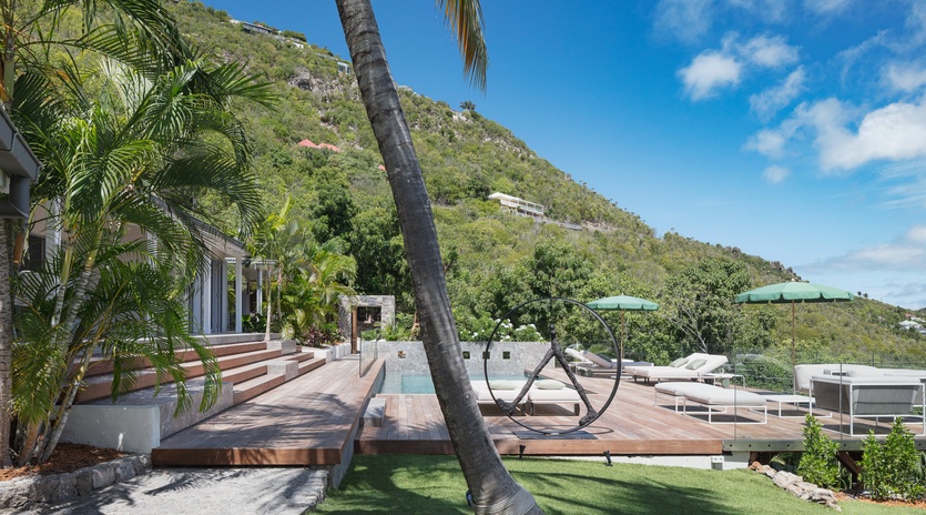 Your private tropical oasis awaits with lush palm shade, sparkling pool, and mountain views creating the perfect Caribbean escape.