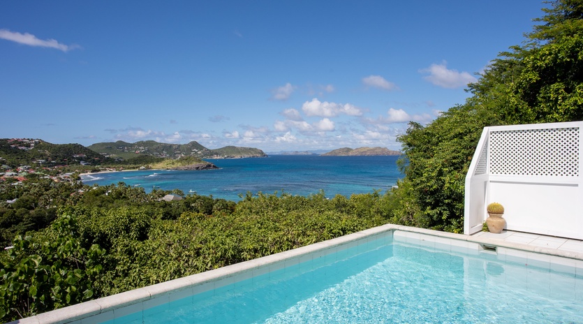 Stunning infinity pool overlooking turquoise Caribbean waters and tropical islands creates the perfect backdrop for your island getaway.