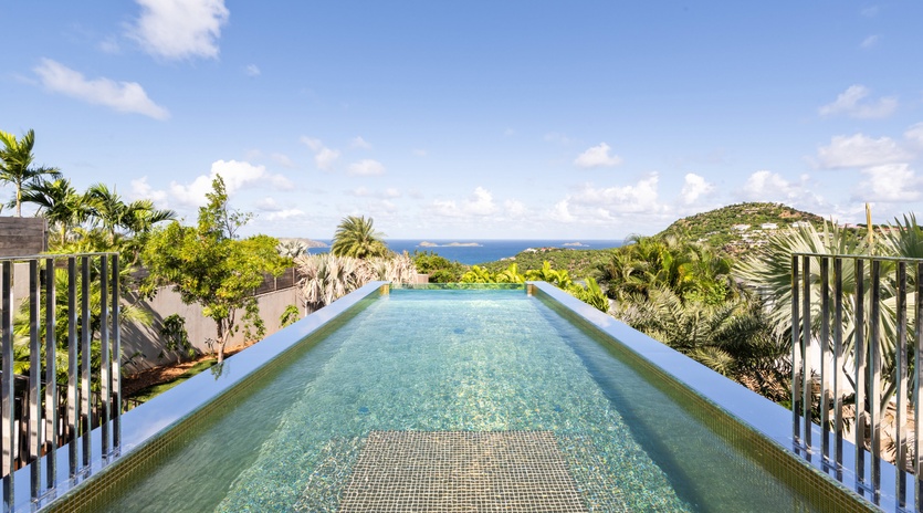 Dive into your private infinity pool as tropical breezes carry ocean scents and panoramic views stretch endlessly before you.
