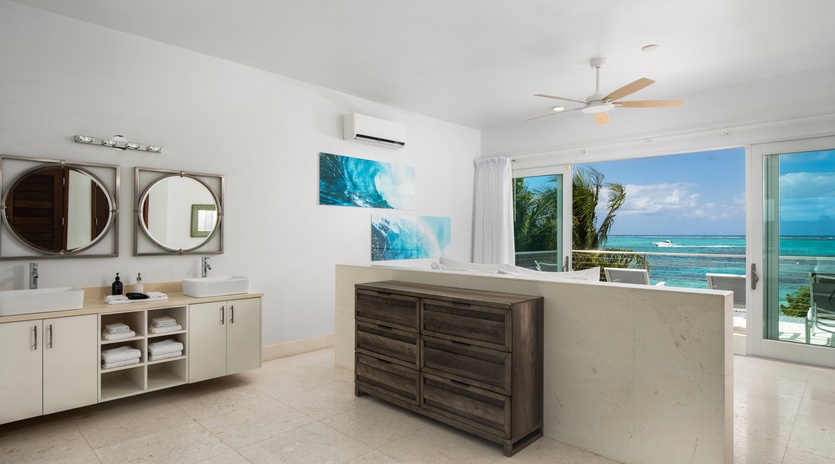 Step into your luxurious master suite where dual sinks and stunning ocean views create your perfect morning routine.