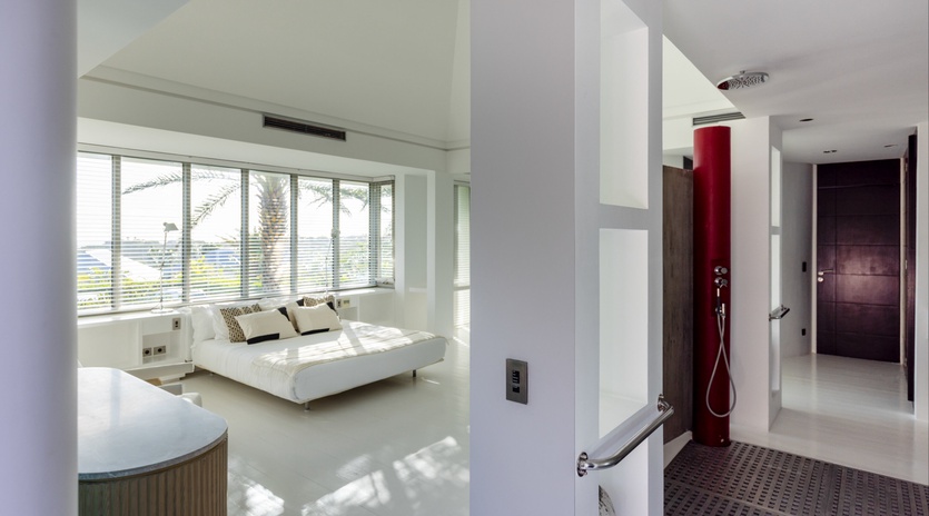 Sink into your spacious white bed as natural light filters through your panoramic windows, creating the perfect sanctuary for relaxation.