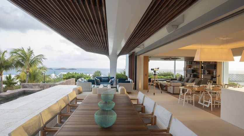 Stunning open-air dining space where you'll savor meals under the modern pergola, with ocean breezes and tropical views framing every moment.