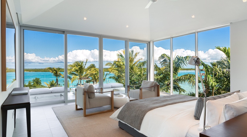 Wake up to stunning ocean views through floor-to-ceiling windows that frame turquoise waters and swaying palms perfectly.