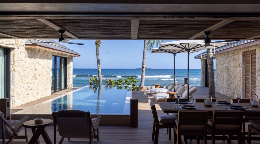Dine overlooking your infinity pool with the ocean stretching endlessly beyond, creating the perfect backdrop for your tropical getaway.
