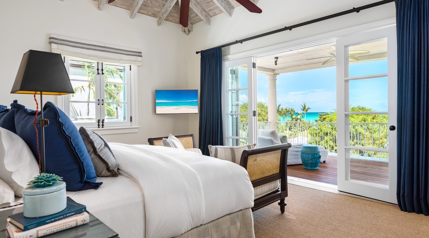 Sink into crisp linens and wake to turquoise waters framing your private balcony—your peaceful island retreat with breathtaking sea views awaits.