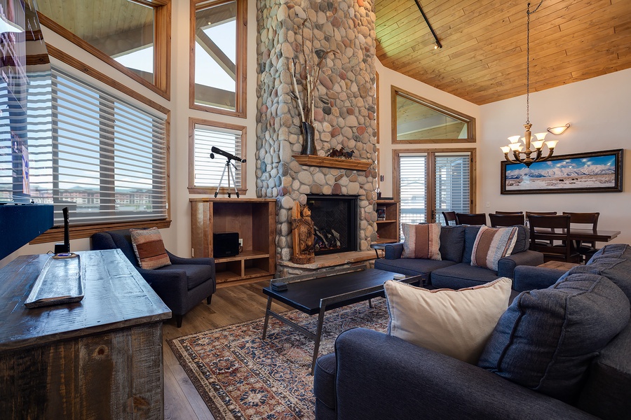 Gather by the towering stone fireplace or sink into plush seating with cathedral ceilings and warm wood surrounding you. Your mountain escape awaits in this inviting great room.