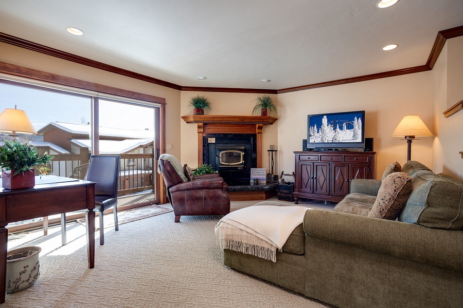 Settle into your private living room, where a cozy fireplace, plush seating, and TV create the perfect spot for unwinding after mountain adventures.