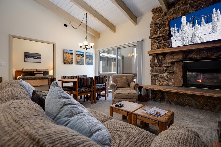 Curl up on plush sofas by the crackling stone fireplace, where rustic wood beams and cozy textures invite you to unwind after a day of mountain adventures.