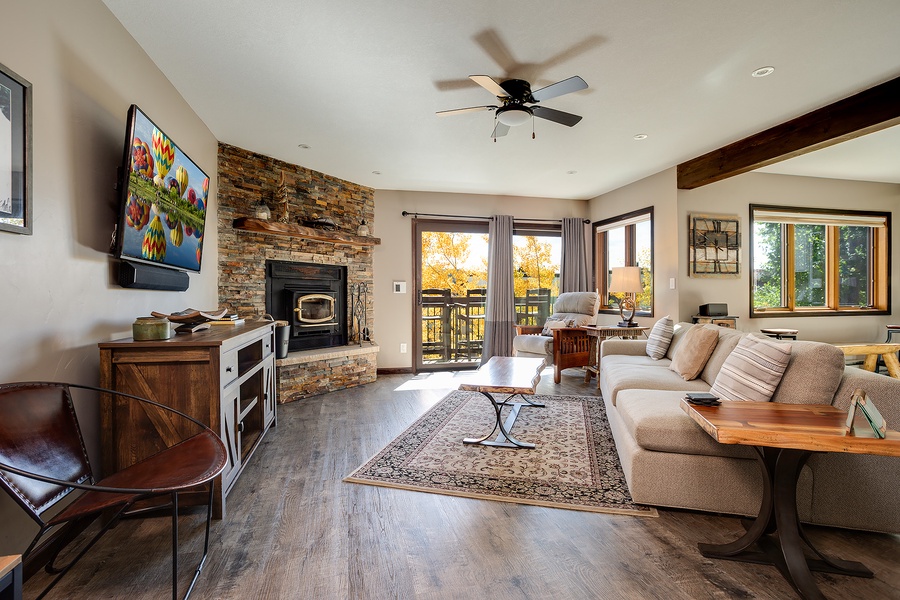 Sink into the plush sofa by the stone fireplace, enjoy autumn views from your private balcony, and unwind with your favorite show on the wall-mounted TV—your perfect mountain retreat awaits.