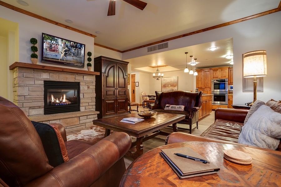 Sink into plush leather seating by the warm stone fireplace, enjoy your favorite shows, and take in the seamless flow into a fully equipped kitchen—your perfect retreat awaits.