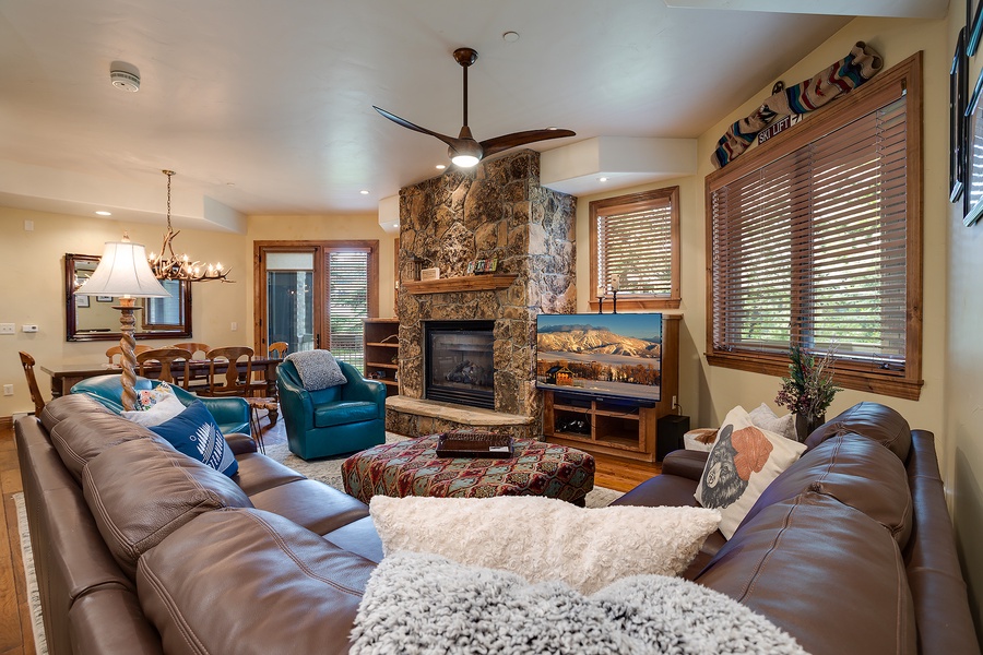 Sink into plush leather sofas by the stone fireplace, where mountain views and warm wood accents create your perfect après-ski retreat.