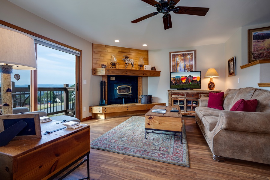 Relax in your spacious living room with a cozy fireplace, comfortable seating, and stunning lake views from your private balcony—perfect for unwinding after a day of adventure.