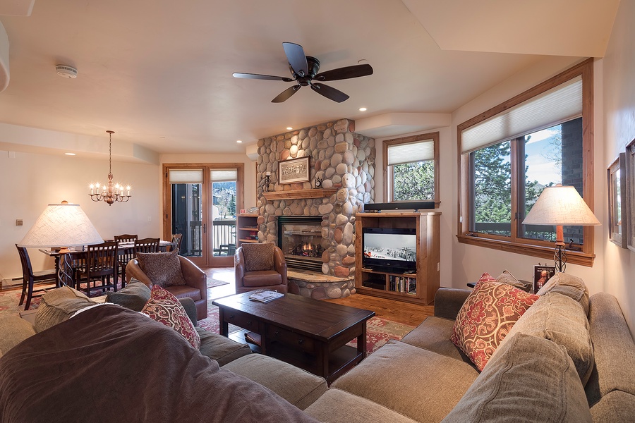 Sink into plush sofas by the stone fireplace as natural light fills your cozy retreat. Perfect for unwinding after a day of mountain adventures, with room to gather and make memories together.