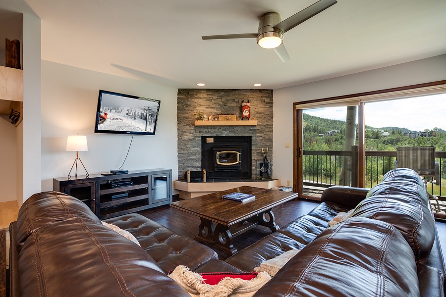 Sink into plush leather sofas and enjoy mountain views from your private balcony, with a cozy fireplace setting the perfect mood for evenings in.