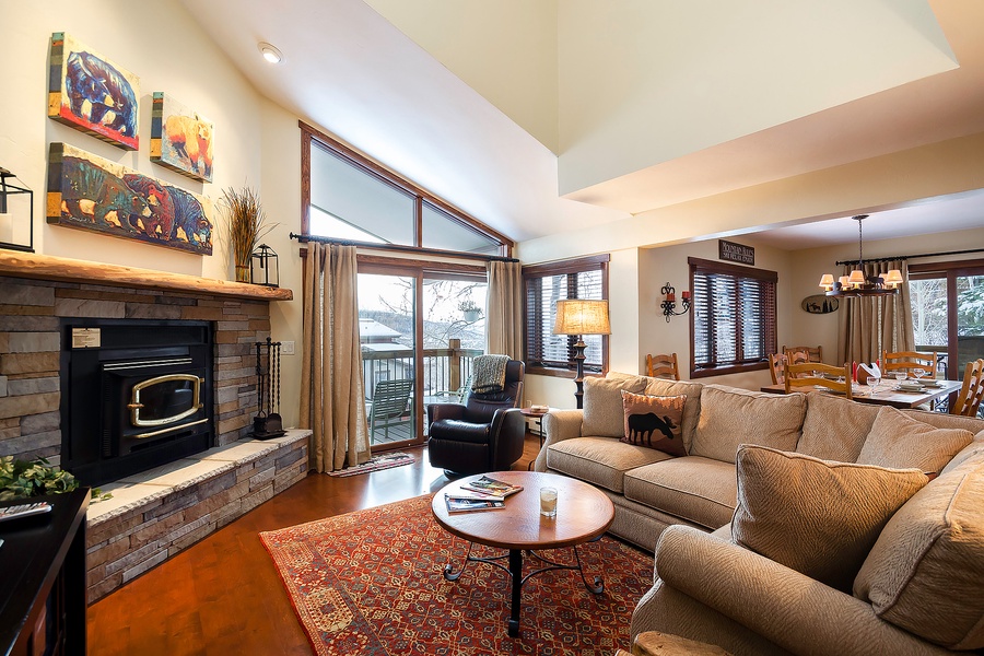 Sink into plush sofas by the cozy fireplace, where vaulted ceilings and abundant natural light create your perfect mountain retreat for relaxing evenings.