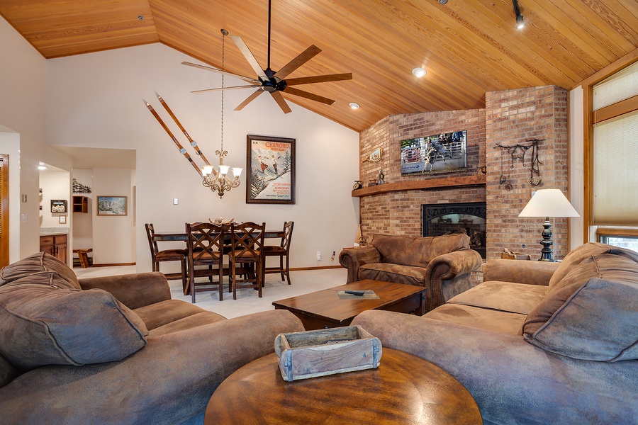 Sink into plush sofas by the warm glow of your stone fireplace, while vaulted wood ceilings and mountain-inspired décor create a welcoming alpine retreat.
