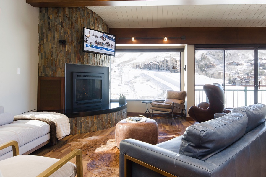 Sink into plush leather seating by your cozy fireplace and gaze at spectacular ski slopes right outside your window—your perfect mountain retreat awaits.