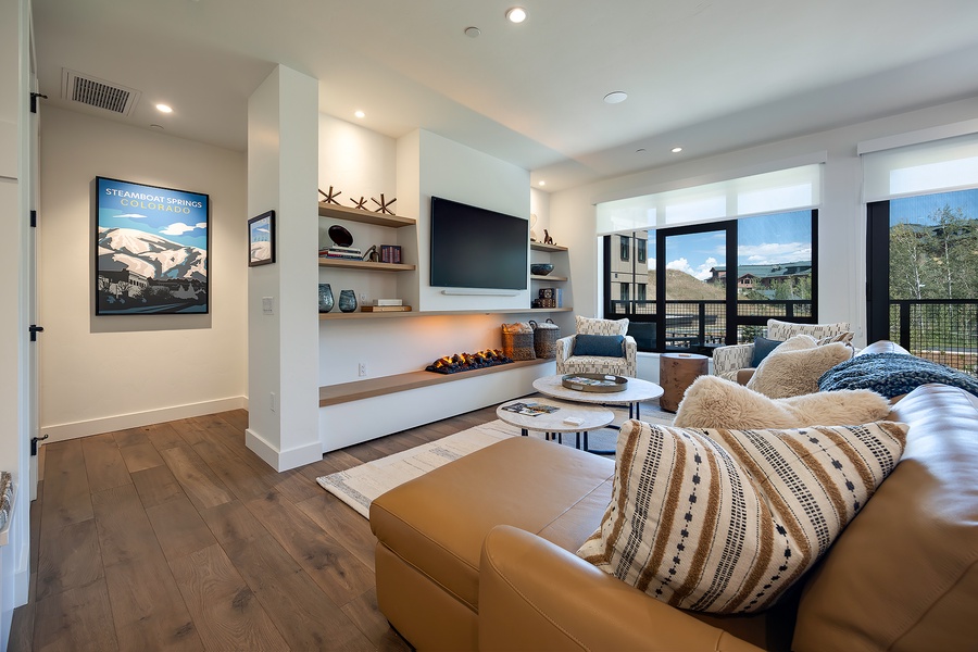 Sink into plush seating and enjoy your favorite shows in this bright, inviting living room with mountain views framing your stay.