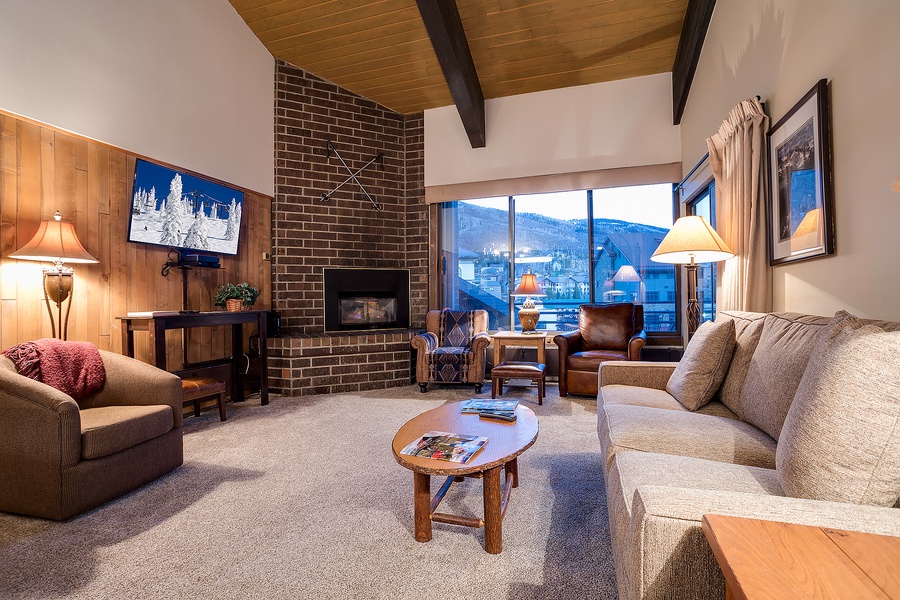 Curl up on plush seating by the fireplace and watch the snow-dusted mountains through expansive windows—your perfect mountain retreat awaits.