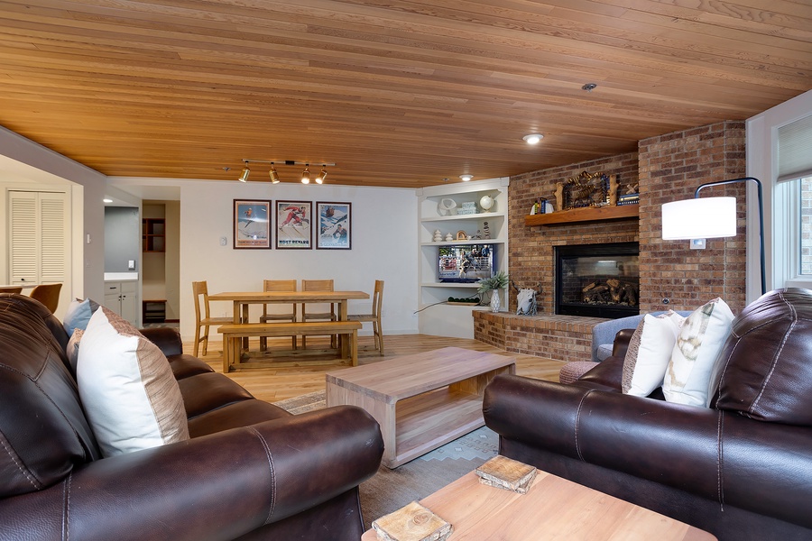 Sink into plush leather sofas by the warm fireplace, gather around the dining table, and enjoy your mountain getaway under beautiful wood-paneled ceilings.